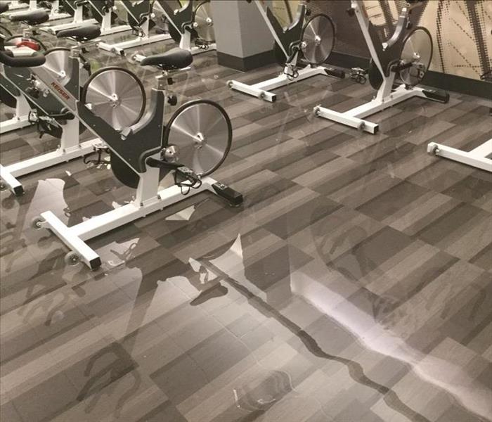 Flooded gym with gym equipment.